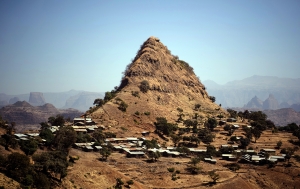 A village sits below a prominent hill in the Simien mountain range, near Gondar, Ethiopia, on January 20, 2017